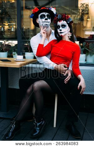 A Couple, Wearing Skull Make-up For. All Souls Day. Boy And Girl Sugar Skull Makeup.painted For Hall