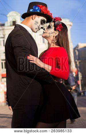A Couple, Wearing Skull Make-up For. All Souls Day. Boy And Girl Sugar Skull Makeup.painted For Hall