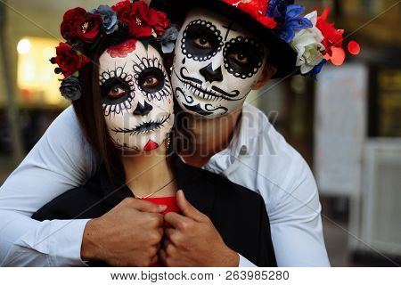 A Couple, Wearing Skull Make-up For. All Souls Day. Boy And Girl Sugar Skull Makeup.painted For Hall