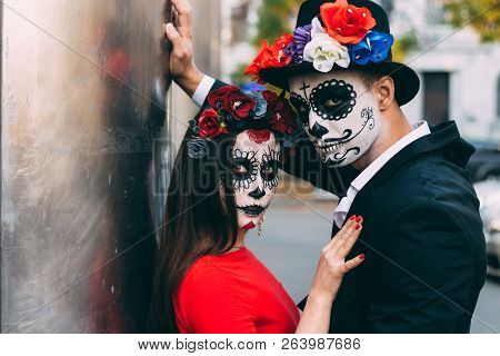 A Couple, Wearing Skull Make-up For. All Souls Day. Boy And Girl Sugar Skull Makeup.painted For Hall