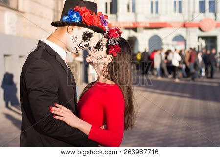 A Couple, Wearing Skull Make-up For. All Souls Day. Boy And Girl Sugar Skull Makeup.painted For Hall