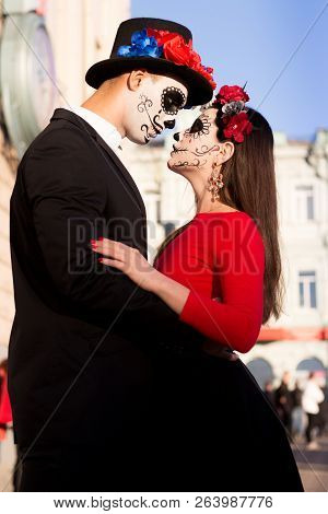 A Couple, Wearing Skull Make-up For. All Souls Day. Boy And Girl Sugar Skull Makeup.painted For Hall