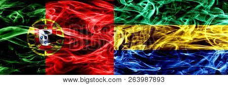 Portugal Vs Gabon, Gabonese Smoke Flags Placed Side By Side. Thick Colored Silky Smoke Flags Of Port