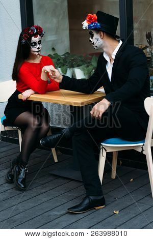 A Couple, Wearing Skull Make-up For. All Souls Day. Boy And Girl Sugar Skull Makeup.painted For Hall