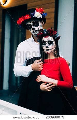 A Couple, Wearing Skull Make-up For. All Souls Day. Boy And Girl Sugar Skull Makeup.painted For Hall
