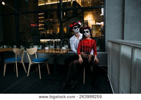 A Couple, Wearing Skull Make-up For. All Souls Day. Boy And Girl Sugar Skull Makeup.painted For Hall