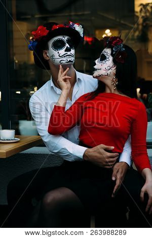 A Couple, Wearing Skull Make-up For. All Souls Day. Boy And Girl Sugar Skull Makeup.painted For Hall