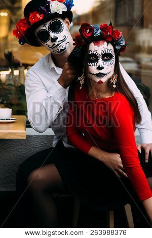 A Couple, Wearing Skull Make-up For. All Souls Day. Boy And Girl Sugar Skull Makeup.painted For Hall