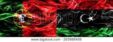 Portugal Vs Libya, Libyan Smoke Flags Placed Side By Side. Thick Colored Silky Smoke Flags Of Portug