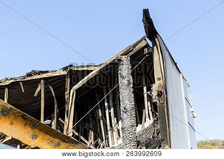 Damaged Roof Industry Supermarket After Arson Fire With Burn Debris Of Twisted Metal Structure After
