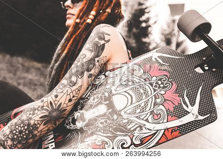 Ufa, Russia - September 12, 2018 Editorial Photo Of Young Girl With Tattoo And Dreadlocks Sitting In