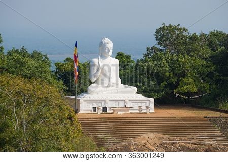 View Of The Sculpture Of The Sitting Buddha On A Sunny Morning. Mango Plateau. Mihintale, Sri Lanka