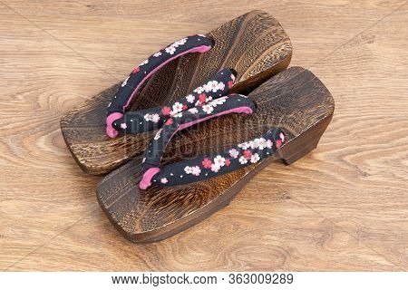 Japanese Traditional Geta Sandal On Wooden Floor. Traditional Japanese Asian Wood Footwear Called Ge