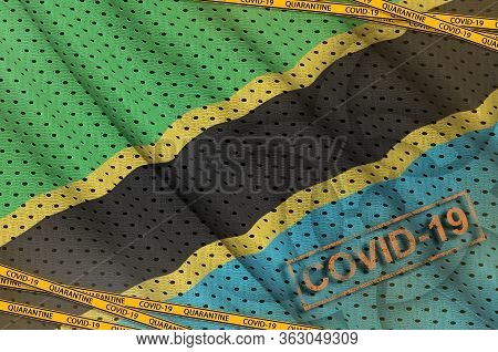 Tanzania Flag And Covid-19 Biohazard Symbol With Quarantine Orange Tape And Stamp. Coronavirus Or 20