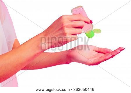 Woman Bride In White Dress Hand Applying Hand Sanitizer On A Pink Background In The Studio