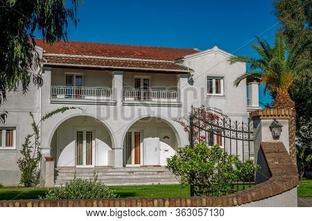 Corfu Island/greece- May 5, 2019: View Of Villa And Small Garden In Gouvia Village - House With Whit