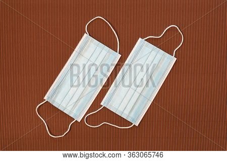 Surgical Protective Masks On A Brown Background. Covid19 Or Coronavirus Prevention.