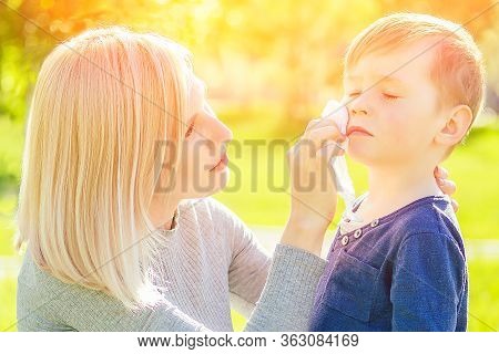 Beautiful Mother Wipes Her Sons Hands With Wet Hygienic Napkins Antibacterian Sanitizer Gel In The P