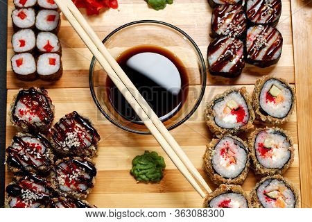 Tasty And Delicious Hot And Cold Sushi Rolls On The Table. Different Sushi - Rolls With Sauce On The