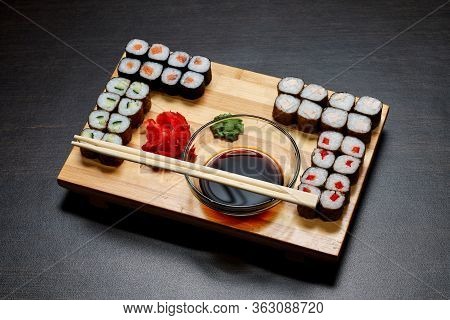Tasty And Delicious Hot And Cold Sushi Rolls On The Table. Different Sushi - Rolls With Sauce On The