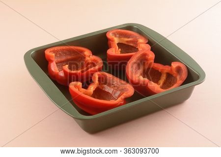 Fresh Raw Red Bell Pepper Halves In Non Stick Baking Pan For Cooking Before Stuffing