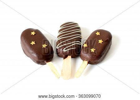 Three Chocolate Popsicle On A Stick Isolated On White Background. Thawed Popsicle.