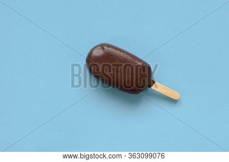 Chocolate Popsicle On A Stick On A Blue Background