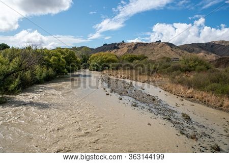 Flooded River With Fast Flowing Dirty Silty Water After Heavy Rain