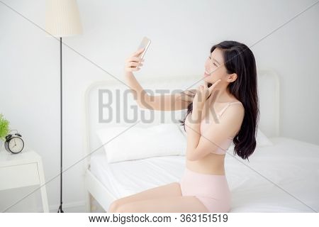 Beautiful Young Asian Woman Sexy In Underwear Talking A Selfie On Smartphone For Social Network In T