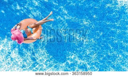 Beautiful Woman In Hat In Swimming Pool Aerial Top View From Above, Young Girl In Bikini Relaxes And