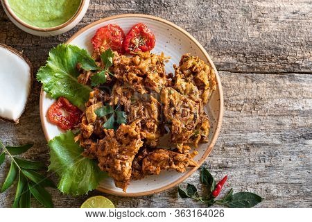 Indian Cuisine. Pakora Traditional Indian Deep-fried Snack. Pakoras On Black Plate With Coconut Chut