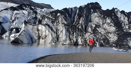 Solheimajokull, Iceland - May 2019: Unidentified Man Standing By Solheimajokull Outlet Glacier And T