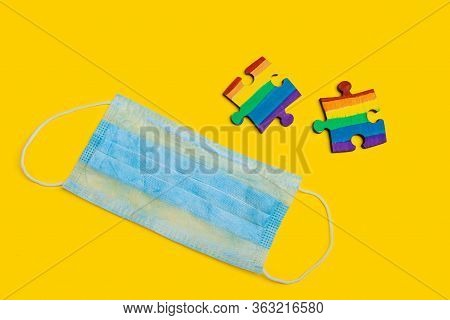 Lgbt Symbol Of The Rainbow On Two Halves Of A Puzzle Next To A Medical Mask. Pride Day 2020