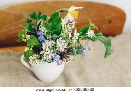 Spring Wildflowers In Vintage Cup On Rustic Wooden Table. Blooming Colorful Flowers Of Ajuga, Forget