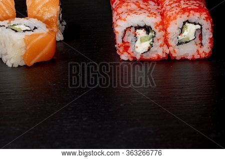 Philadelphia Roll With Salmon, Cheese And Cucumber On A Black Background. Sushi Philadelphia