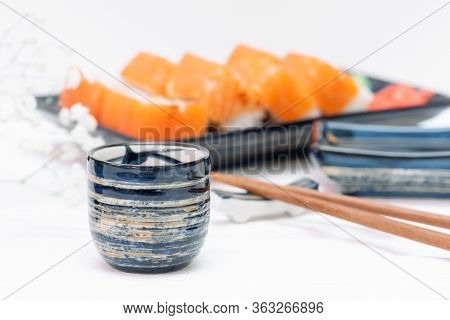 Sake Drink On A Sushi Rolls Background.