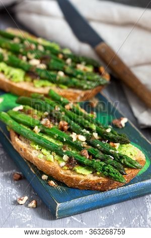 Vegan Whole Grain Bread Sandwich With Asparagus, Pea Puree, Nuts And Soy Sauce.