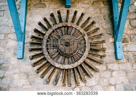 The Wheel Of A Water Mill. The Old Wooden Wheel Of The Water Mill Is Used As An Element Of Decor On 