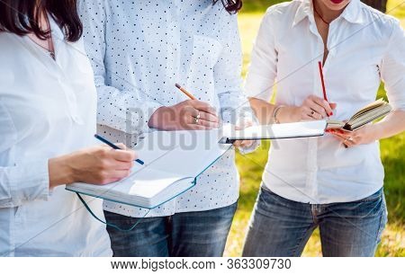 Young Beautiful Girls Drawing The Pictures In Sketchbook.