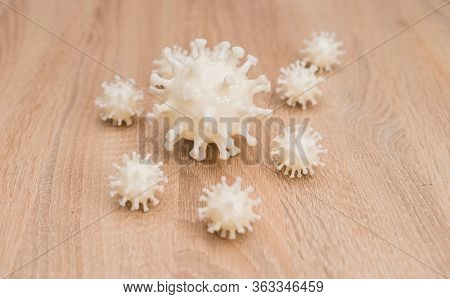 covid19, 3d printed representation of the virus on a wooden surface. home security and protection against viruses