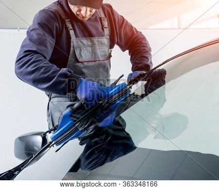 Automobile Special Workers Replacing Windscreen Of A Car In Auto Service