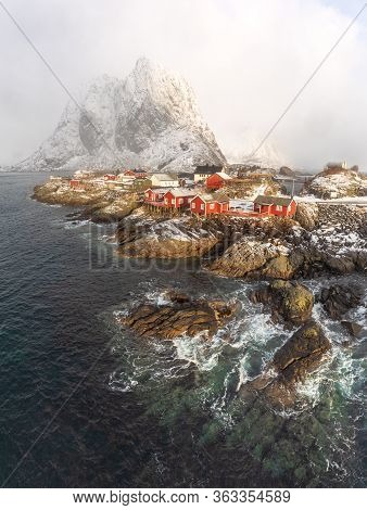 Splendid Winter Day At Hamnoy - Popular Touristic Destination Of Lofoten. Late Sunlight Lights Red H
