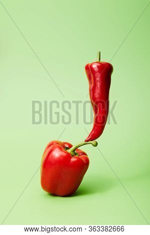 Chili Pepper On Red Bell Pepper On Green