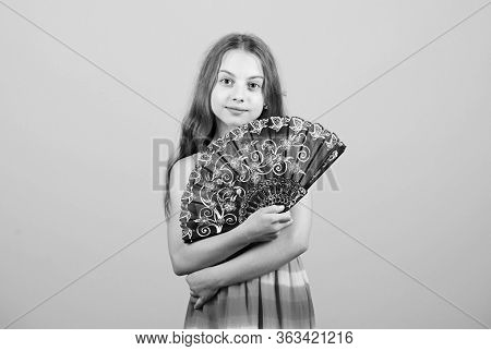 Cooling And Ventilation. Waving To Create Current Air. Little Girl Waving Elegant Fan. Summer Heat. 