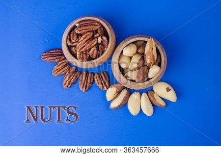 Pekan And Brazil Nuts On Blue Background. Healthy Food