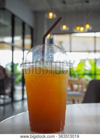 Cold Iced Tea With Lemon And Straw In Takeaway Plastic Cup. Cold Refreshing Cocktails In Take Away G