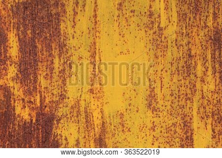 Metallic Wall Background, Texture, Colored In Fiery Yellow Color. Old Rusty Metal Surface With Faded