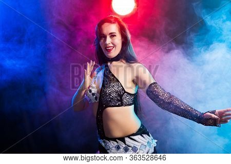 Girl Dancing Belly Dance, Fusion Or Tribal. A Woman In A Beautiful Costume Demonstrates Charming And