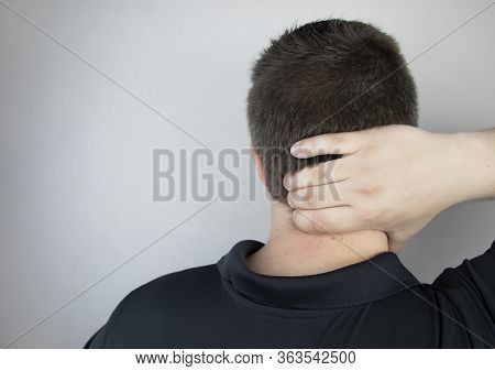 A Man Suffers From Pain In The Neck, Massages The Cervical Spine With His Hand. Osteochondrosis, Her