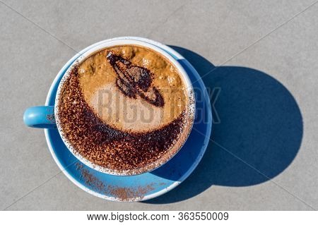 Latte Art Coffee Decoreded With Saturn Image In Blue Cup From Mt John, Tekapo, New Zealand